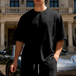 Close-up detail of mens black textured knit t-shirt outfit, stylish casual streetwear look.