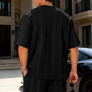 Detailed view of men's casual textured knit short sleeve t-shirt in black streetwear style.