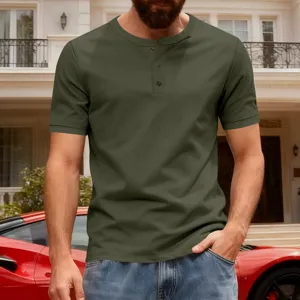Detail view of men's short sleeve olive green Henley shirt with button placket in casual setting.