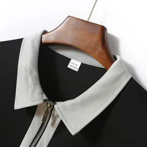 Men's polo shirt detail showcasing the stylish contrast lapel collar, zipper placket and soft fabric.