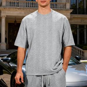 Detail view of mens grey jacquard knit oversized short sleeve t shirt and shorts lifestyle.