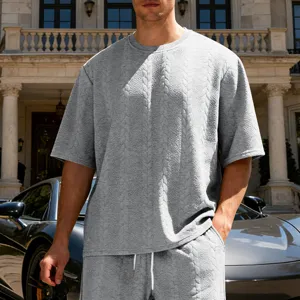 Men's grey oversized jacquard knit crewneck short sleeve t-shirt and shorts set detail.