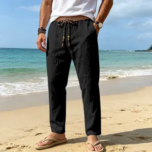 Detail view of men casual beach linen pants with ethnic waistband in scenic seaside setting.