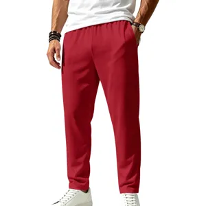 Close-up shot of men's red casual trousers, showing premium lightweight fabric details.