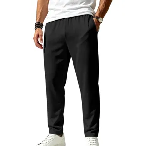 Detail shot of men's black quick-dry breathable casual sports pants with straight-leg stretch fit.