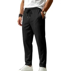 Close-up view of black quick-drying men's casual pants with elastic drawstring waist.