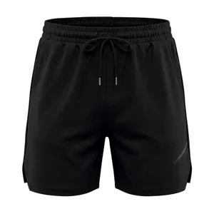 Black mesh athletic shorts detail showing breathable fabric, elastic drawstring waist and side trim.