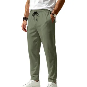 Close-up view of men's olive green casual pants featuring an elastic drawstring waistband.