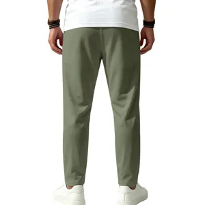 Back view detail of men's quick-drying stretch casual trousers in green for outdoor sports.