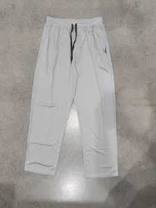 Men's breathable quick-dry casual straight sports pants detail showing zipper pockets.
