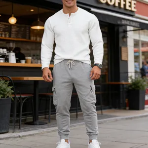 Men's waffle knit henley long sleeve shirt and grey cargo sweatpants casual outfit detail.
