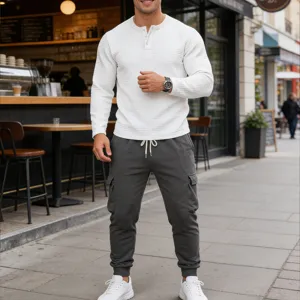 Detailed view of men waffle knit Henley shirt and cargo sweatpants street style outfit.