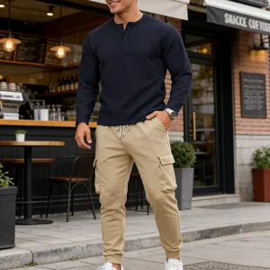 Detail view of mens vintage waffle knit henley shirt and cargo pants set in casual street style.