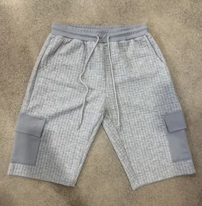 Men's grey grid casual cargo shorts detail, featuring elastic drawstring waist and deep pockets.