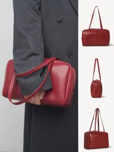 Minimalist red leather bowling shoulder bag, elegant genuine leather tote for women commuter use.