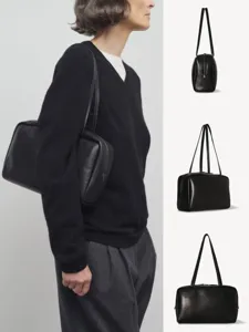 Minimalist black leather shoulder bag, premium lambskin bowling bag for women daily commute.