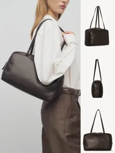 Detailed close-up view of the dark brown leather shoulder bag, showing minimalist design.