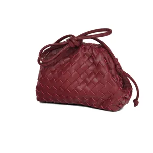 Burgundy woven leather pouch bag detail, classic intrecciato knotted clutch for women.