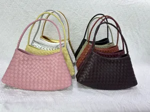 Detailed view of woven leather underarm handbags in multiple colors, elegant shoulder bags.
