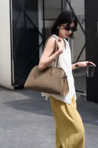 Elegant pebbled leather shoulder bag with long handles, minimalist luxury tote for women.