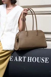 Elegant pebbled leather shoulder bag with long handles, stylish women's tote for daily use.