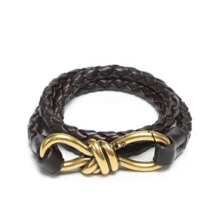 Eleganter dunkelbrauner geflochtener Ledergürtel mit stilvoller goldener Knoopfgesp für Damen.
