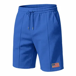 Blue waffle knit men shorts detail view, featuring comfortable drawstring waist and flag patch.