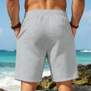 Men's loose casual beach waffle shorts, comfortable sportswear and summer five-point trousers detail view.