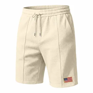 Men's waffle casual shorts summer loose beach five-point pants with drawstring and flag patch.
