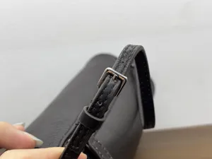 Minimalist cowhide leather 90s shoulder bag detail, premium small crossbody bag for women.