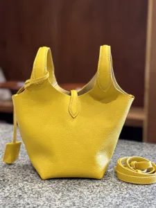 Yellow leather bucket bag detail, premium top-layer cowhide, stylish handbag for women.