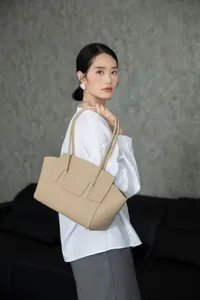Elegant beige leather tote bag for women, featuring chic shoulder straps and premium style.