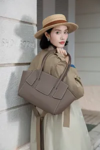 Elegant grey leather tote shoulder bag for women, premium daily commuter handbag accessory.