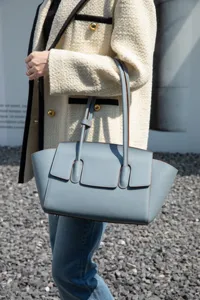 Elegant leather tote bag for women, stylish structured shoulder bag with chic front flap design.