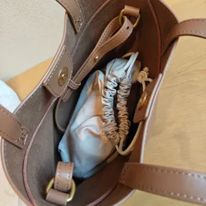 Détail intérieur du sac cabas en cuir marron, sac seau spacieux avec pochette.