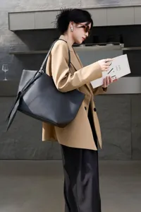 Detailed view of genuine leather tote bag, minimalist large capacity commuting shoulder bag.