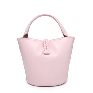 Pink leather bucket bag detail showcasing the exquisite braided handle and center strap.