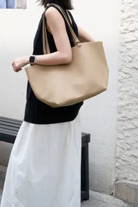 Minimalist beige pebbled leather tote bag, large capacity shoulder bag for women daily commute.