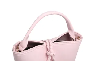 Pink leather bucket bag detail, chic braided knot design, elegant women handbag, stylish accessory.