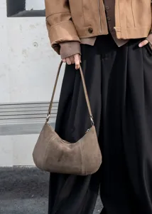 Brown suede underarm shoulder bag detail showing soft leather texture and elegant daily style.