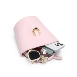 Detail view of pink leather bucket bag showcasing internal capacity, with golden hardware.