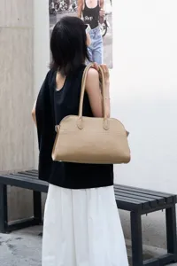 Beige pebble grain leather shoulder bag, stylish EW long handle tote for women daily use.