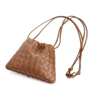 Brown leather woven crossbody bag, stylish dumpling shoulder bag with thin knot strap.