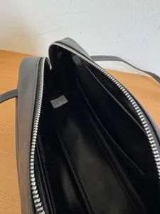 Black leather bowling bag interior detail minimalist structured shoulder handbag details