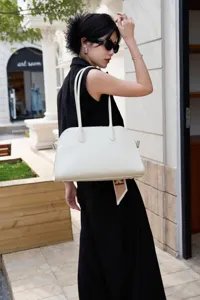 Elegant white leather EW shoulder tote bag with long handles, minimalist luxury design.