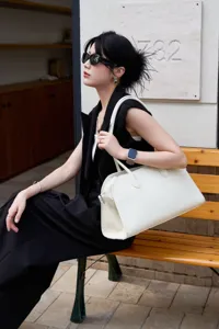 White leather EW tote bag for women, luxury style top handle shoulder bag with pebble grain.