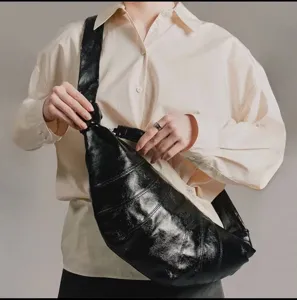 Black croissant shoulder bag women trendy dumpling crossbody bag stylish knotted strap.