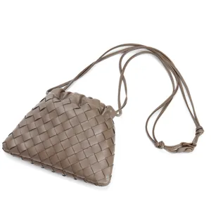 Stylish woven leather shoulder bag for women, trendy dumpling crossbody bag with drawstring design.