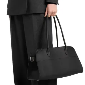 Black leather shoulder bag with long straps, elegant pebble leather tote for women.