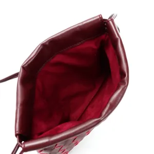 Burgundy leather drawstring pouch detail showing soft interior lining and craftsmanship.
